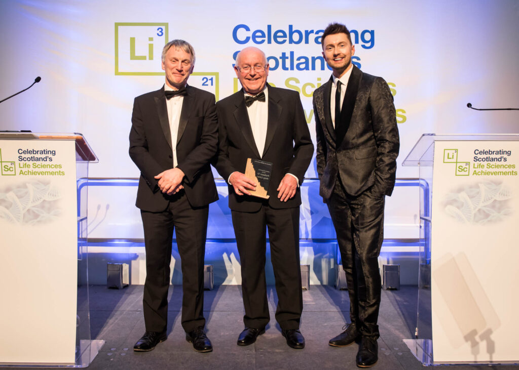 Image of Professor Sir Philip Cohen accepting the Scotland's Lifetime Achievement Award 2023 from Minister Ivan McKee MSP he minister for Business, Trade Tourism and Enterprise and Sean Batty.